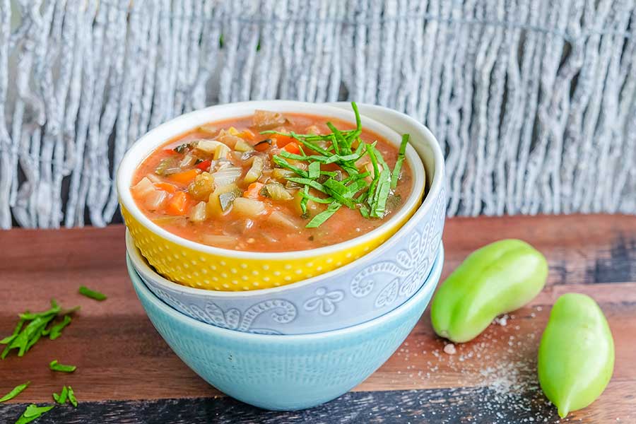 minestroni soup with beans and veggies cooked in an instant pot served in a bowl with herbs