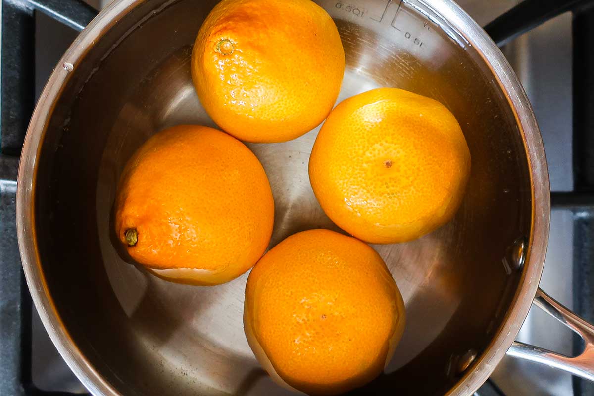 whole mandarins in a pot with water