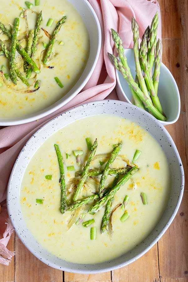 creamy asparagus soup topped with asparagus spears