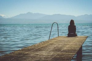 woman sitting on a dock