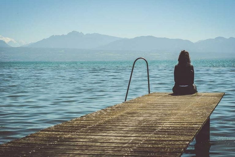 woman sitting on a dock