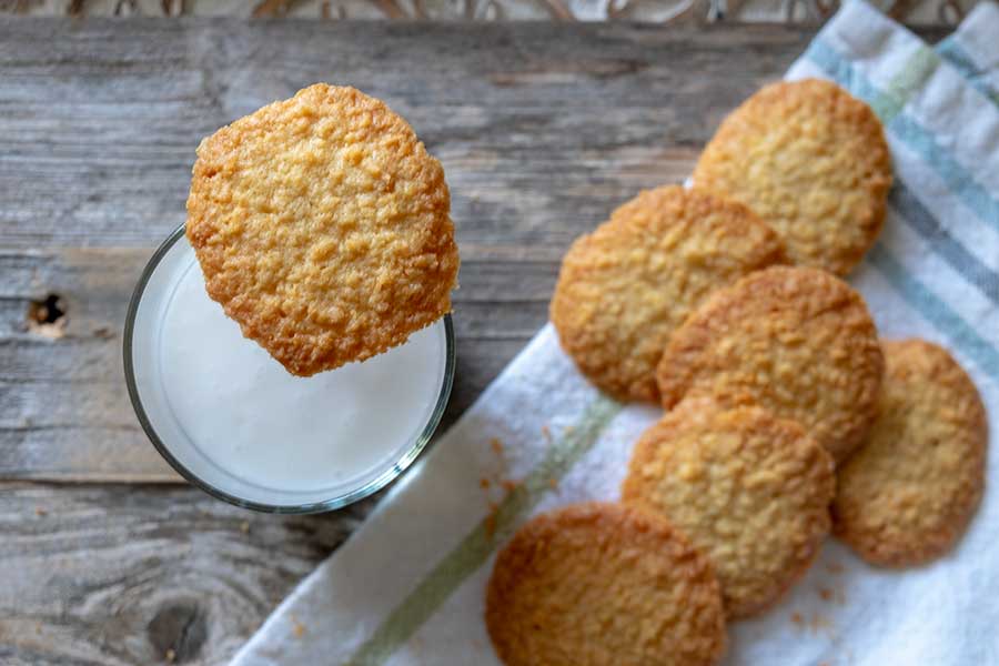 4 ingredient coconut cookies with a glass of milk on the side, gluten free