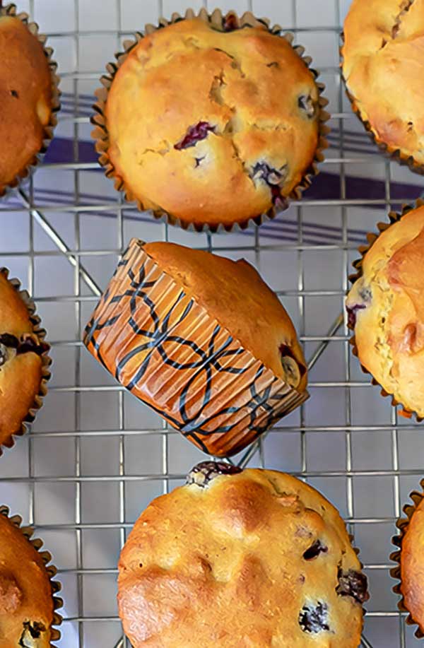 3 gluten-free olive oil muffins on a cooling rack