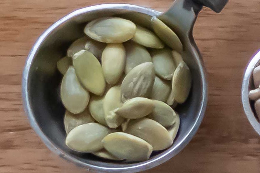 pumpkin seeds in a measuring cup