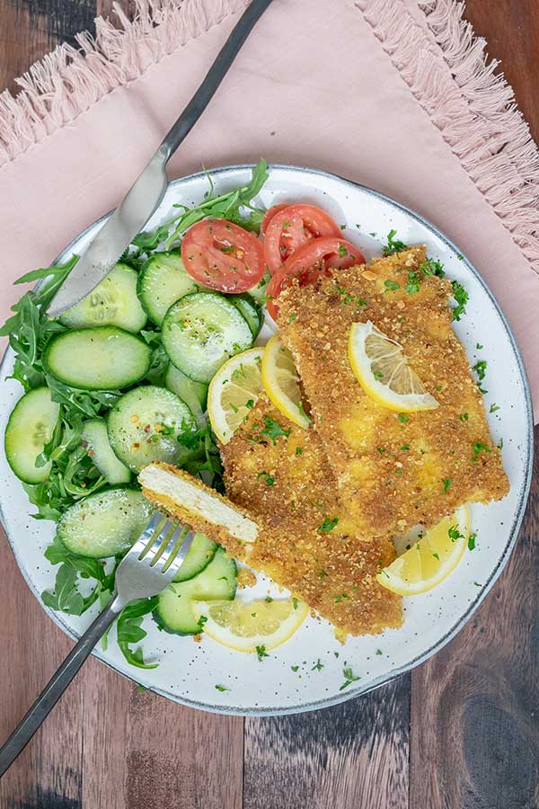 vegan schnitzel with cucumber salad on a plate