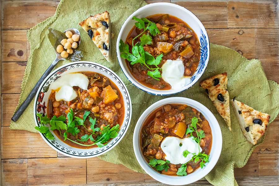 3 bowls of vegetarian chickpea chili with toppings