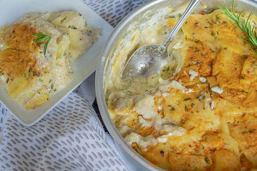 vegan scalloped potatoes in a pot with a spoon