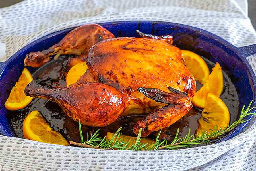 chicken l’orange in a dish with orange wedges