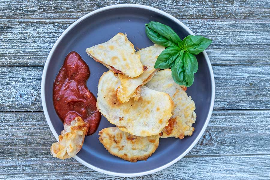 pizza pocket appetizer on a plate with ketchup