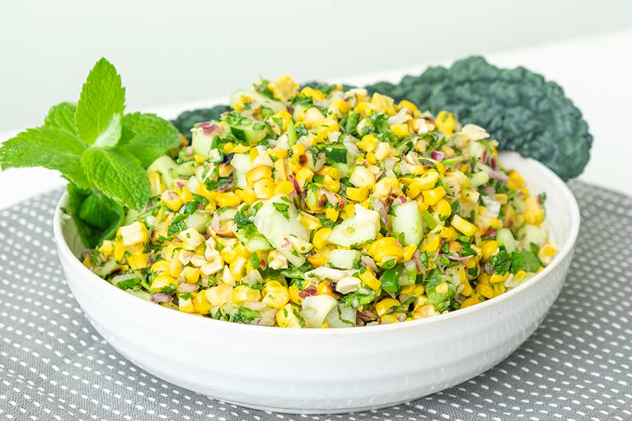 grilled corn salad in a bowl with mint dressing