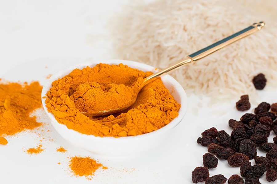 turmeric spice in a bowl with a spoon
