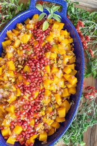 roasted cubed butternut squash with pomegranate and pistachios on a platter