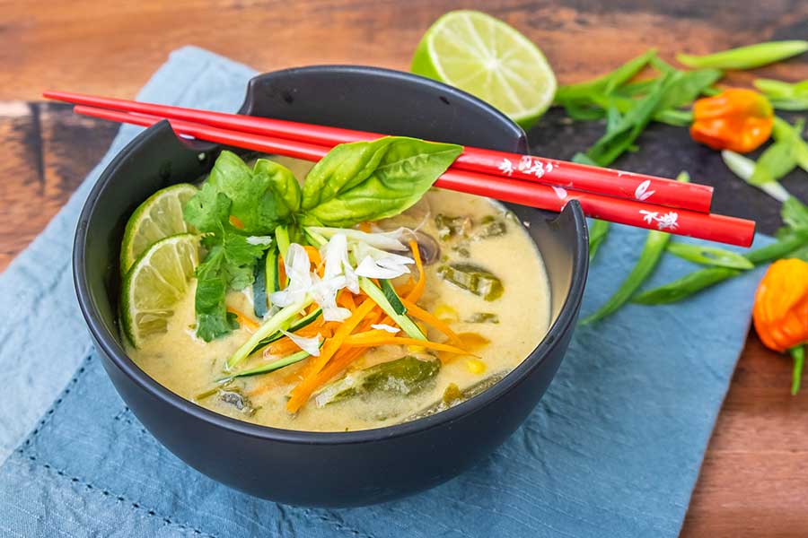 thai chicken soup in a bowl with chopsticks, 