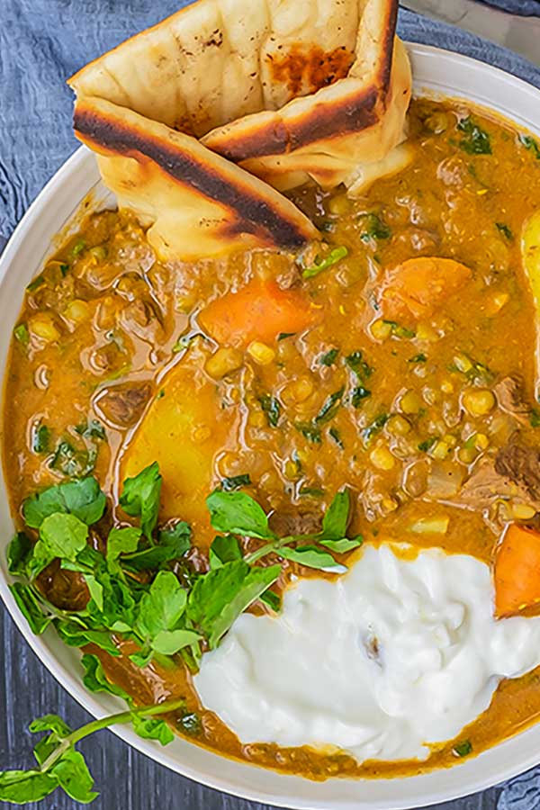 Indian spiced beef stew with naan in a bowl