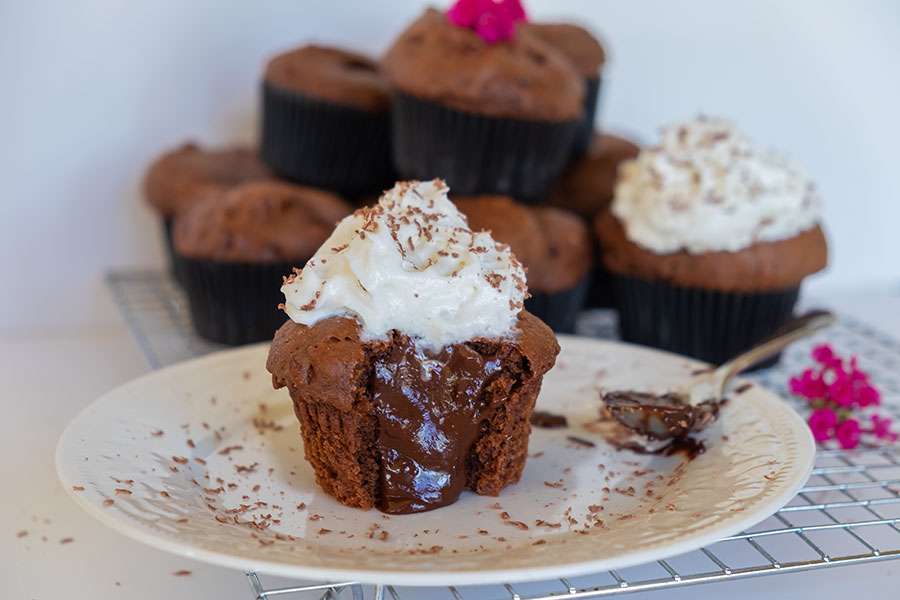 egg-free chocolate filled cupcake with frosting on a plate