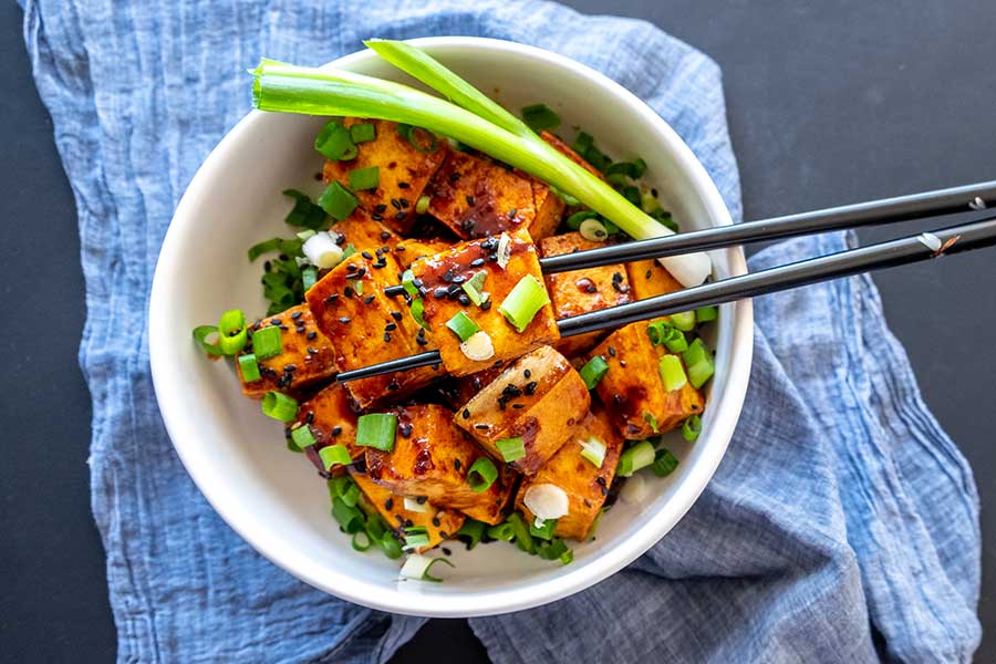 spicy tofu with ginger sauce in a bowl with chopsticks