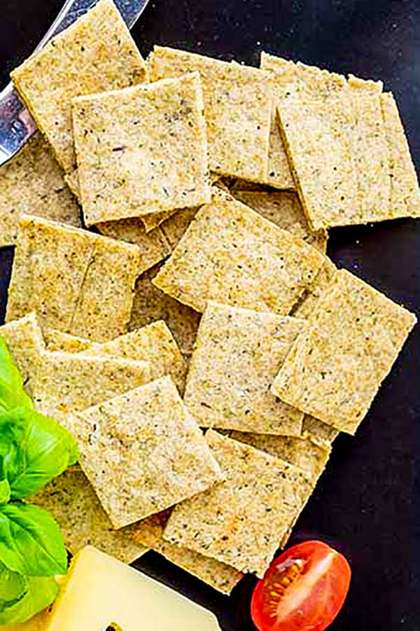 gluten free Italian crackers on a plate with a tomato