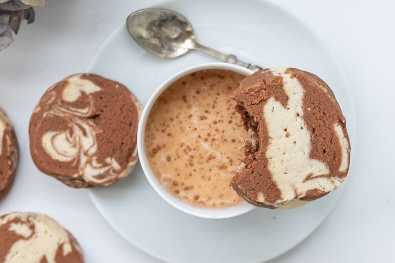 Scrumptions Gluten-Free shortbread Cookie on top of a mug with hot chocolate