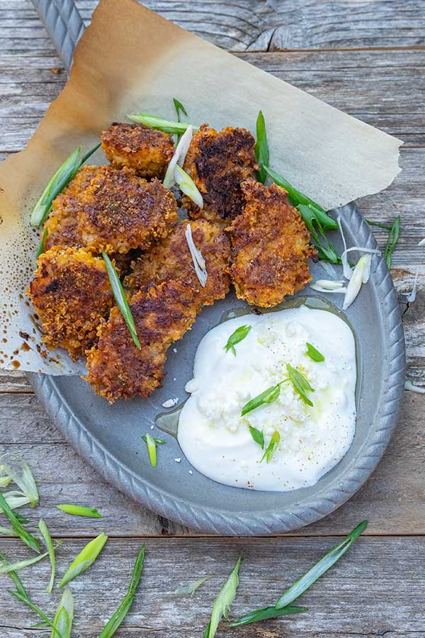 overview of cajun popcorn chicken on a plate with a dip