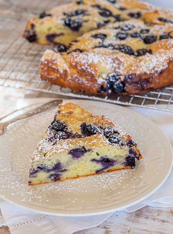 slice of a gluten-free blueberry breakfast cake on a plate