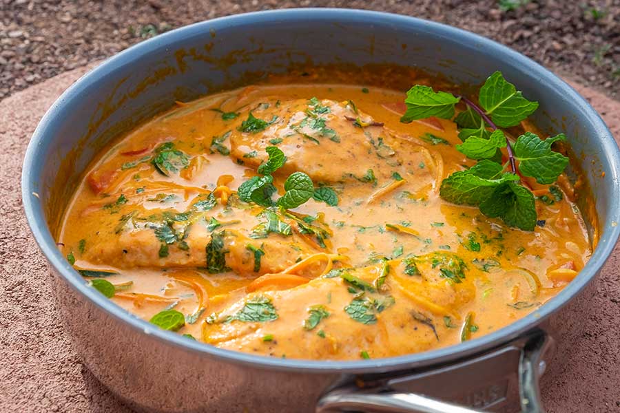 thai salmon in coconut cream sauce in a skillet