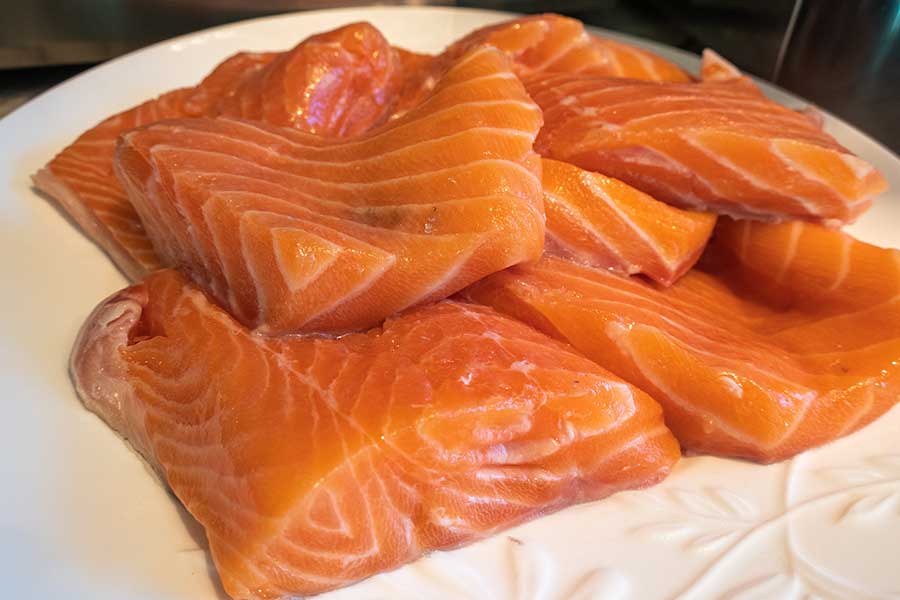 raw salmon slices on a plate