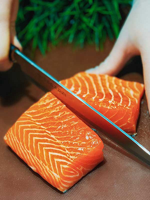 slicing wild salmon with a knife