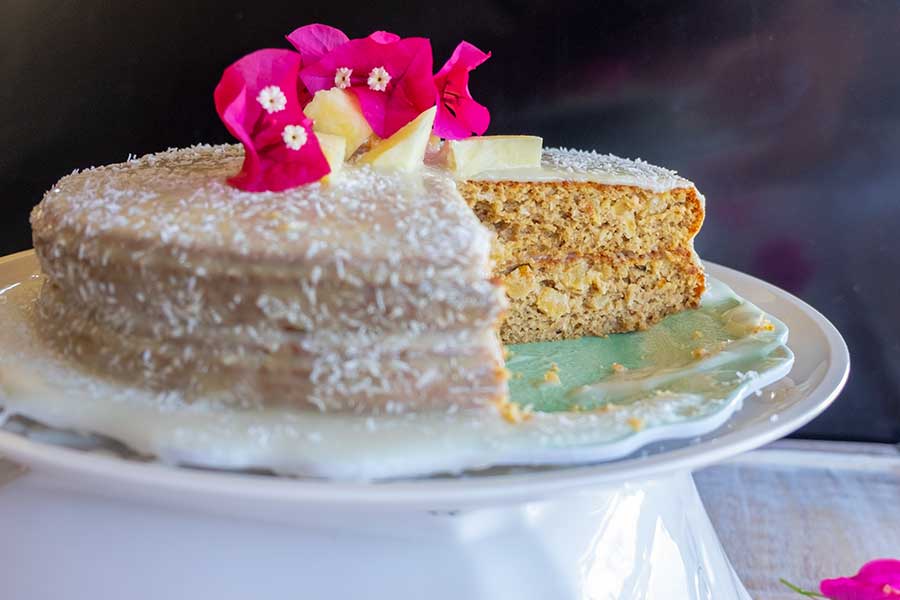 coconut pineapple cake on a cake platter, gluten free