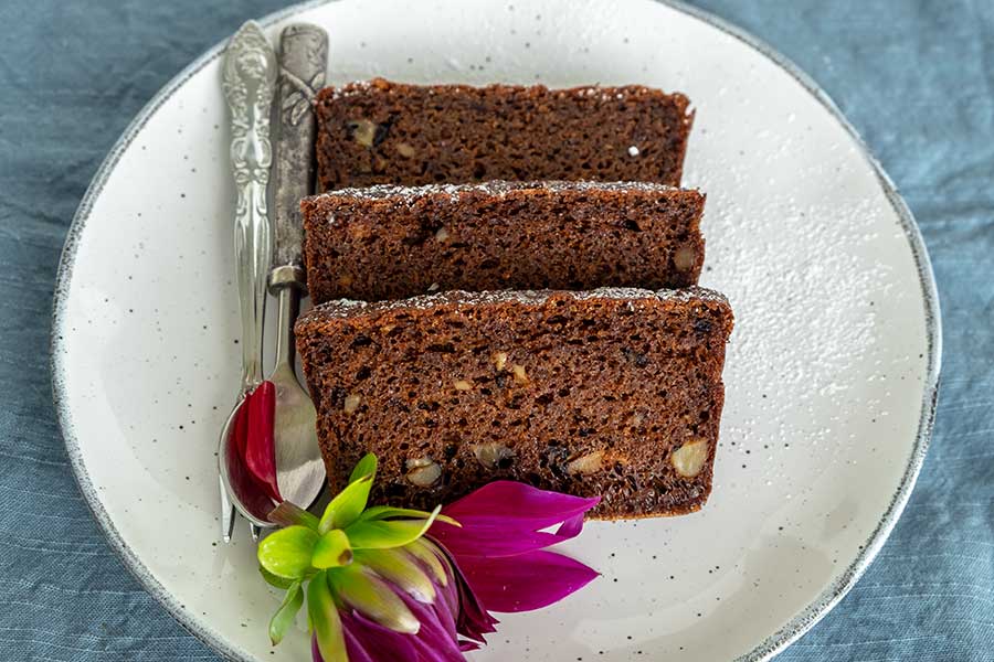 slices of grain-free gingerbread walnut loaf on a plate
