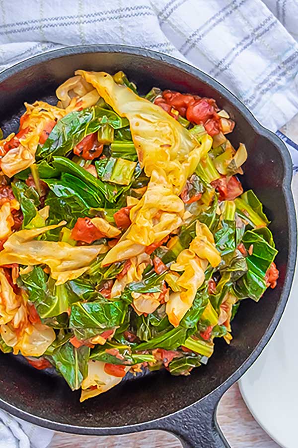 sauteed cabbage and collards in an iron skillet