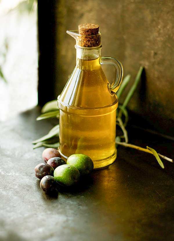 olive oil in a bottle with olives