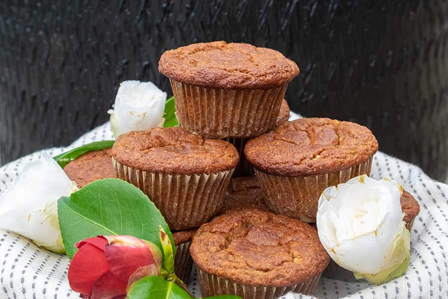 4 stacked banana muffins on a plate