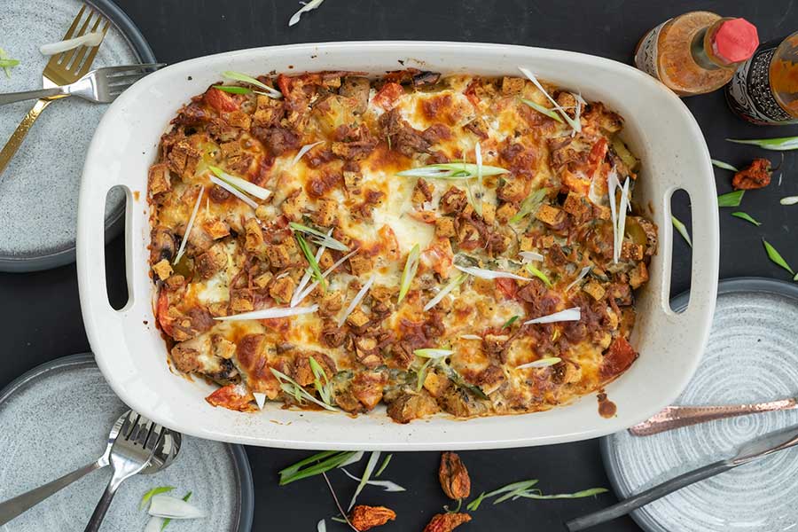 leftovers from the fridge baked in a casserole dish with cheese and bread crumb topping