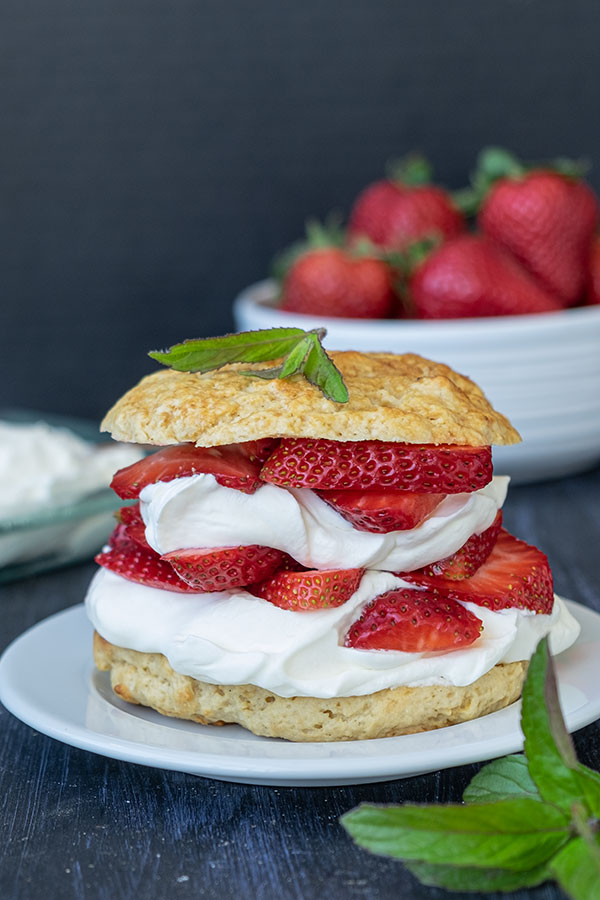 gluten free strawberry shortcake on a plate garnished with mint