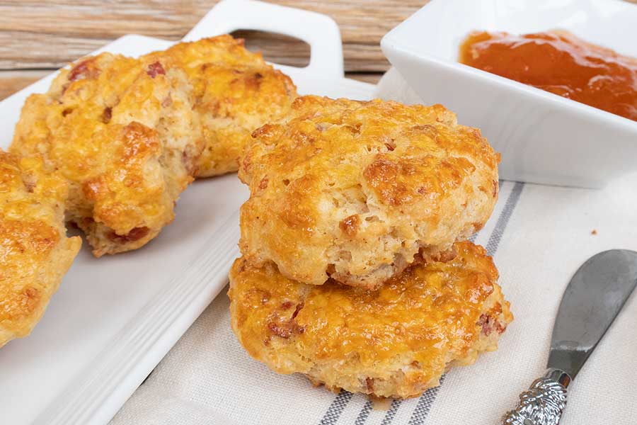 2 gluten free bacon scones stacked on a plate