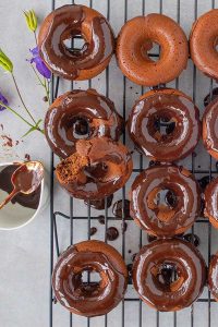 baked chocolate donuts on a cooling rack