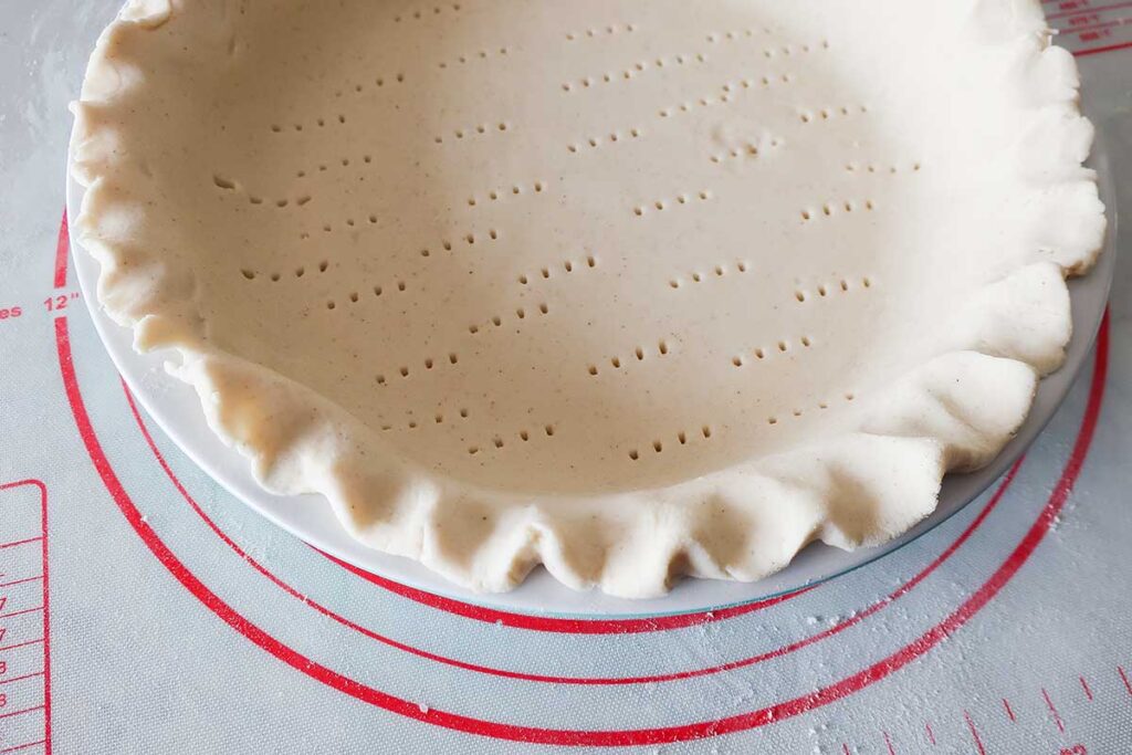 umbaked pie crust dough in a pie dish