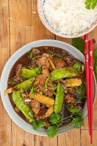 honey garlic pork tenderloin with snow peas in a bowl