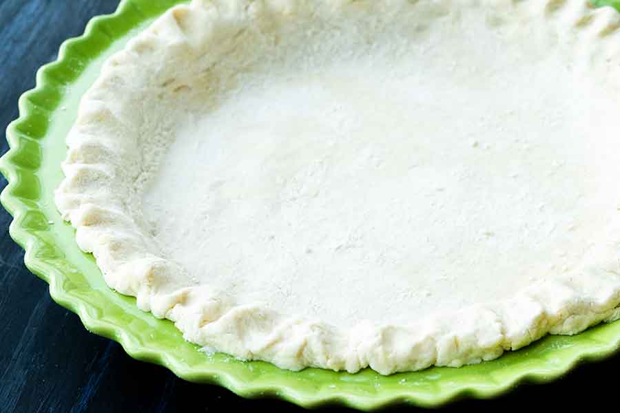 close up of unbaked gluten-free pie crust in a pie dish