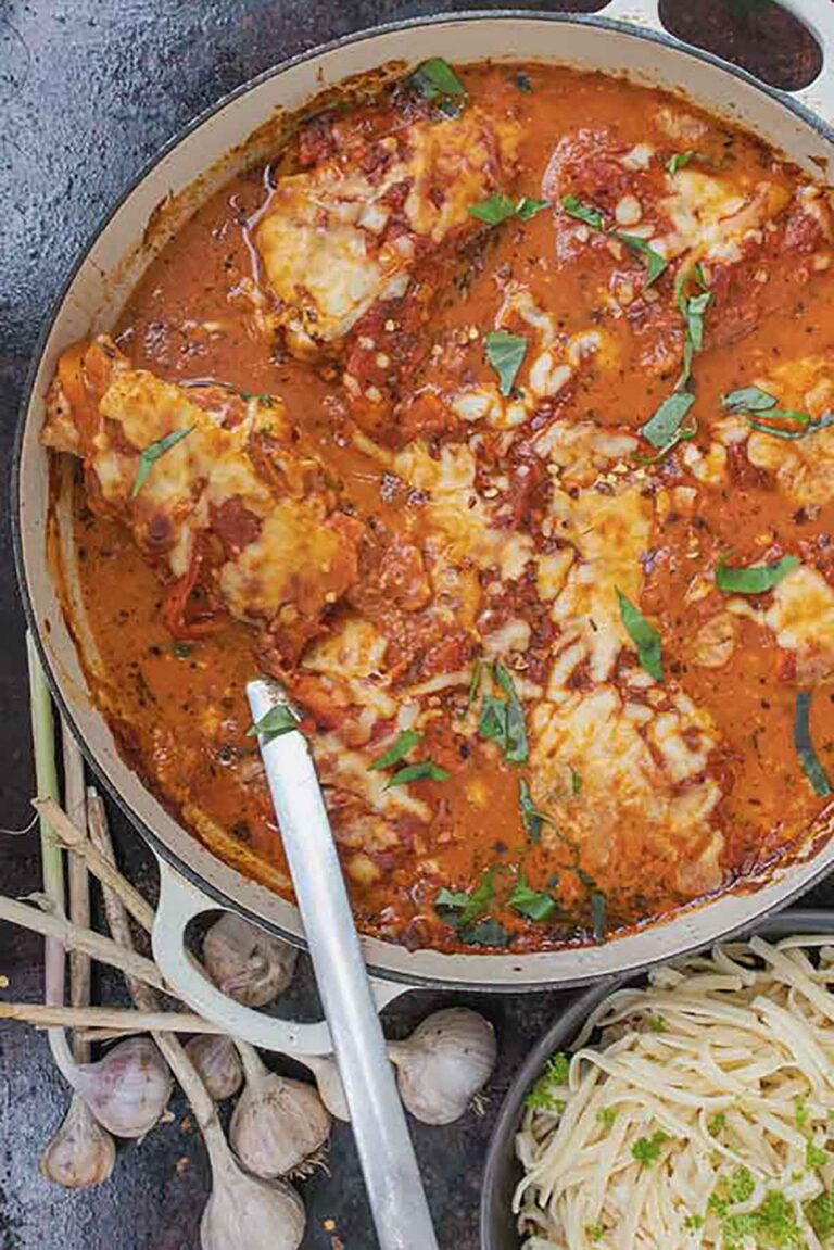 Gluten-free creamy chicken marinara bake topped with melted mozzarella cheese in a skillet