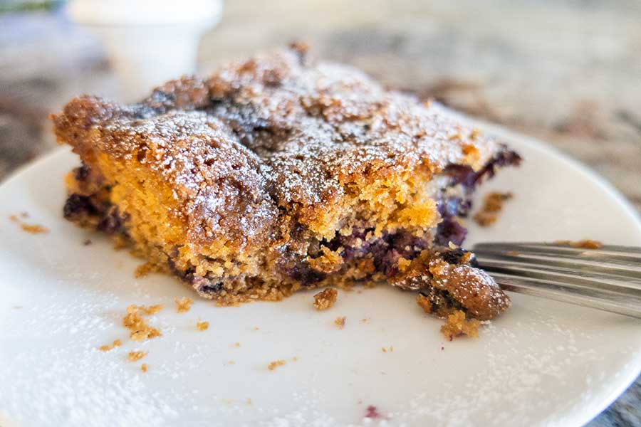 gluten-free blueberry buckle with a fork on a plate