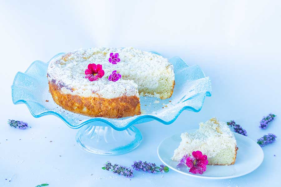 cream cheese vanilla cake on a cake platter, gluten-free