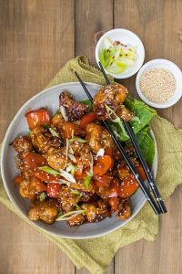 Vegan Kung Pao Cauliflower on a plate with lettuce