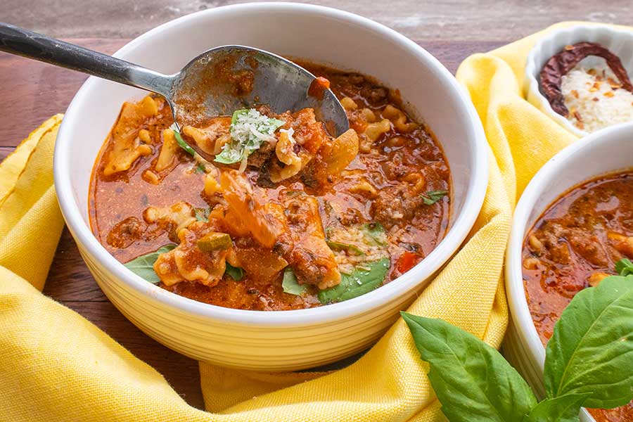 gluten free lasagna soup in bowls with a spoon