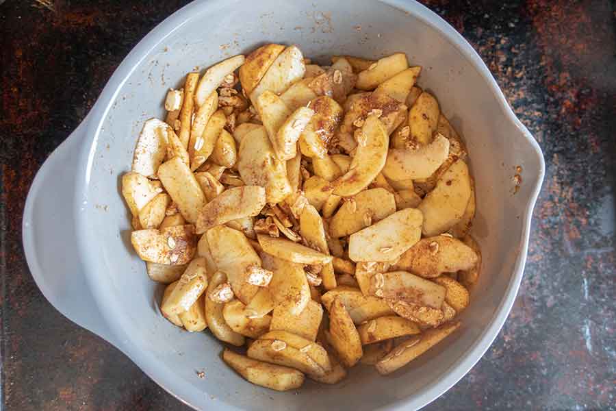 apple with cinnamon in a grey bowl