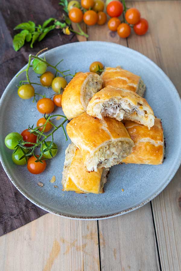 gluten free sausage rolls with tomatoes on a plate