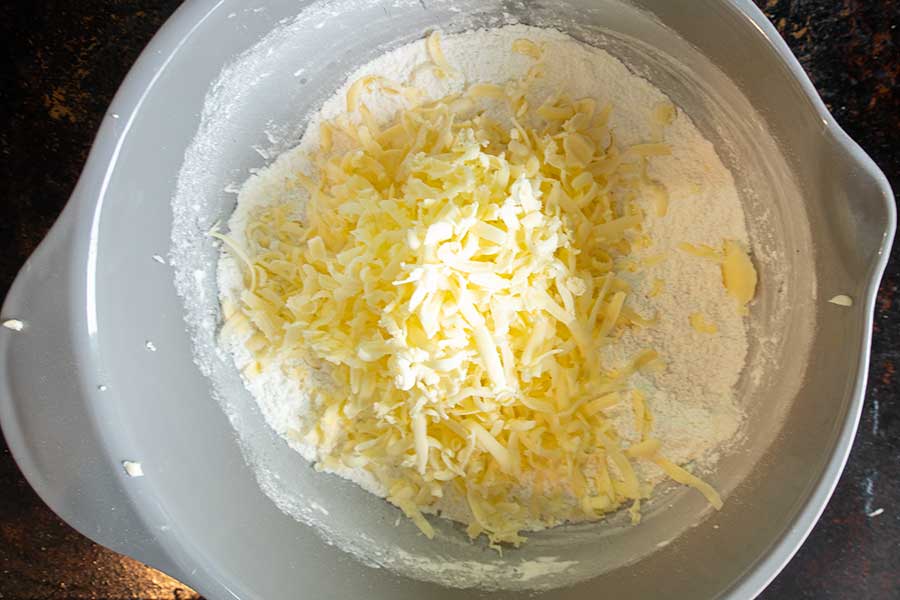 flour and grated butter in a bowl for shortcrust pastry