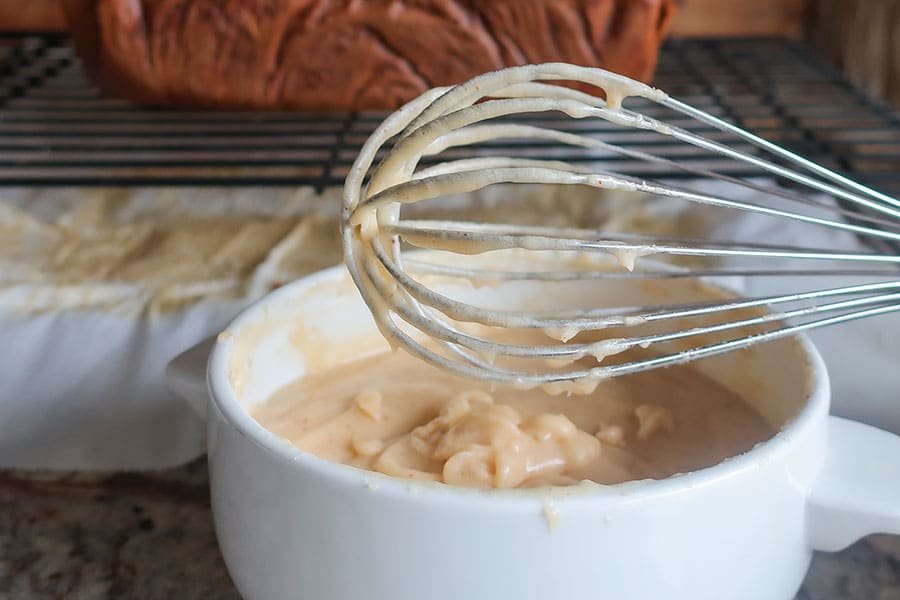 brown butter frosting with a whisk