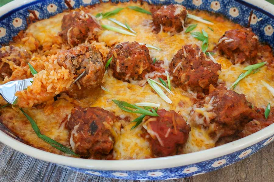 meatballs and rice in a round casserole dish