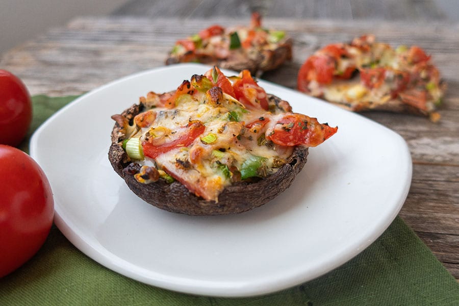 pizza stuffed portobello on a small plate